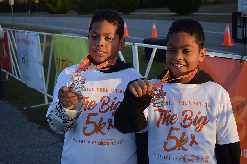 Francisco Flores, 10, and Frankie Flores, 9, show off their medals.