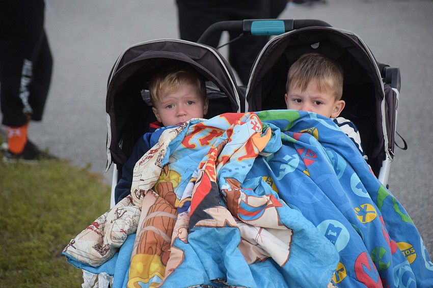 Luke Henry Simmons, 3, and James Simmons, 4, had their own way of warming up before their race. Their dad, Adam Simmons says they would whine some about the cold, but would be excited to get medals for the race.