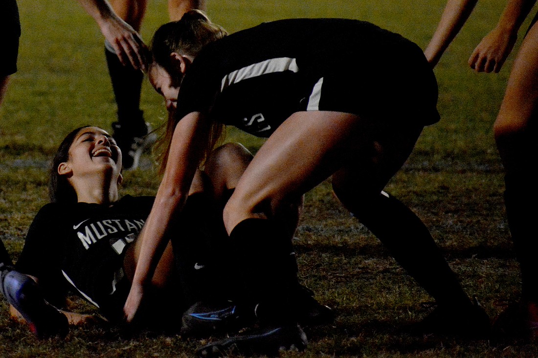 Lakewood Ranch freshman Olivia Hadad laughs as she is picked up off the grass by sophomore Sophie Lemus. Hadad scored a goal in the Mustangs&#39; 4-0 win against Plant City High.