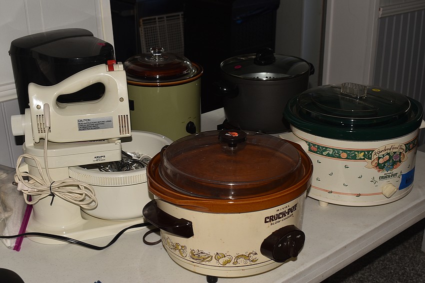 Several crock pots were gathered on one end of the table.