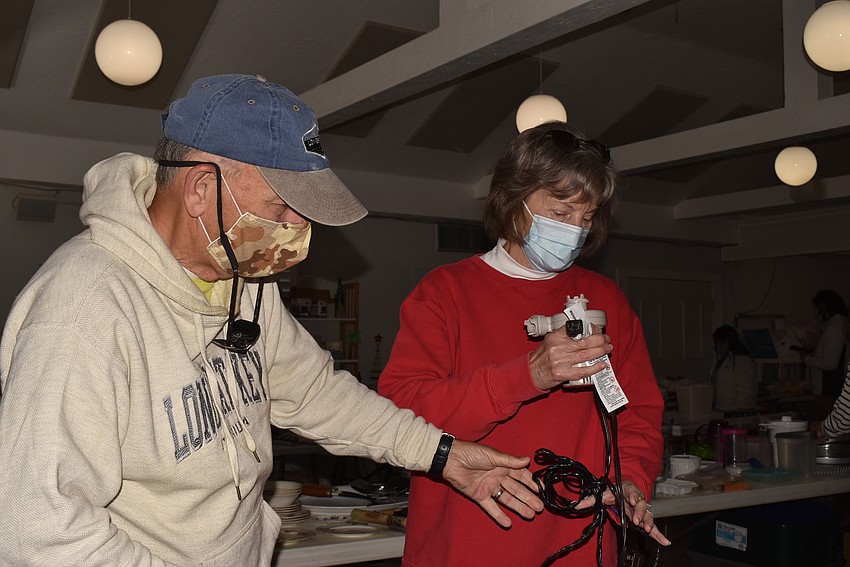 Jim and Nancy Kryway check the functionality of an air mattress pump.