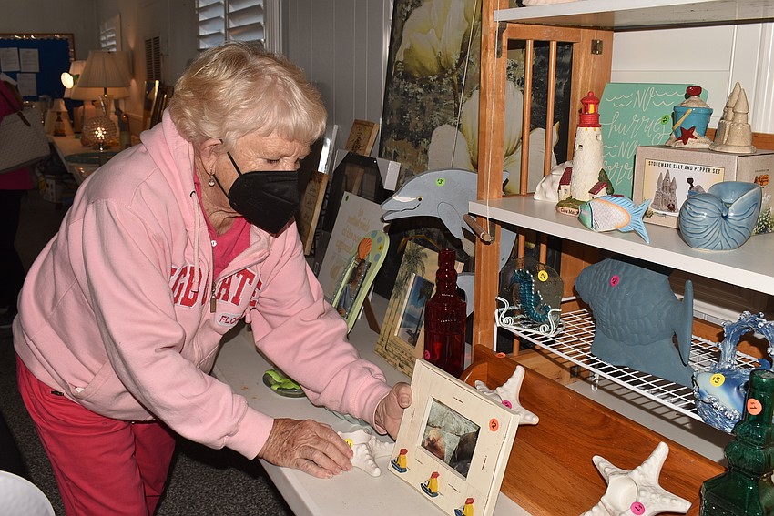 Kay Heigle replenishes frames.