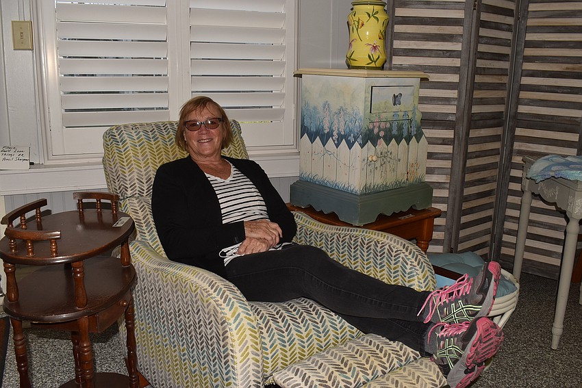 Kathy Conkey tries out a chair.