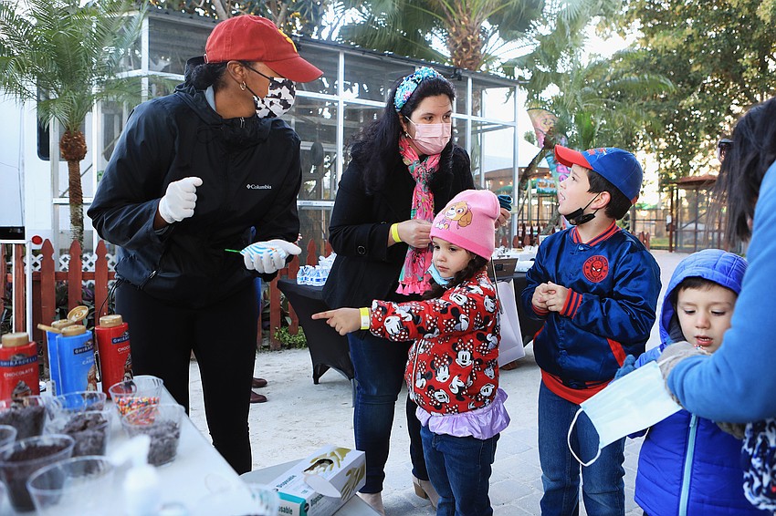 Isabel, Isabella and Joseph Iglesias pick out their treats.
