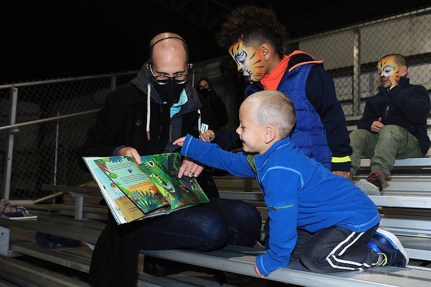 Embracing Our Difference's Ben Jewell-Plocher reads stories to Kyle and Tyler Jalwan