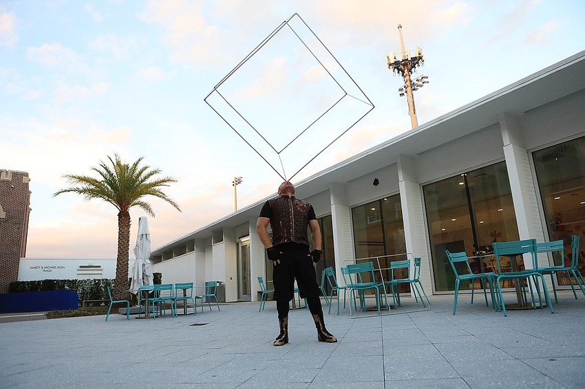 A performer works with a spinner cube outside during the reception.