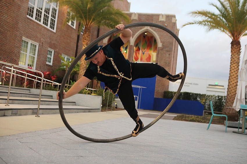 A performer works with a spinner cube outside during the reception.