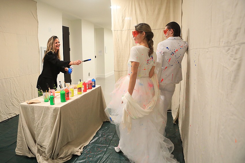 Lissa Murphy tosses paint onto the canvas models