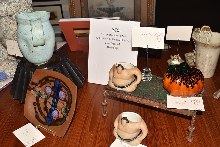 Dozens of pieces were clustered on a table in the middle of the gallery.