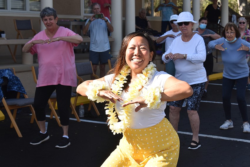Debbie White leads the class in hula.