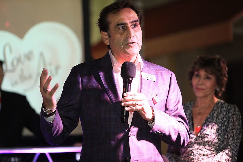 Joseph Grano welcomes the mayor to the event.