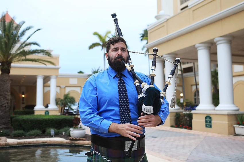 Micah Adams plays the bagpipes for arriving guests.