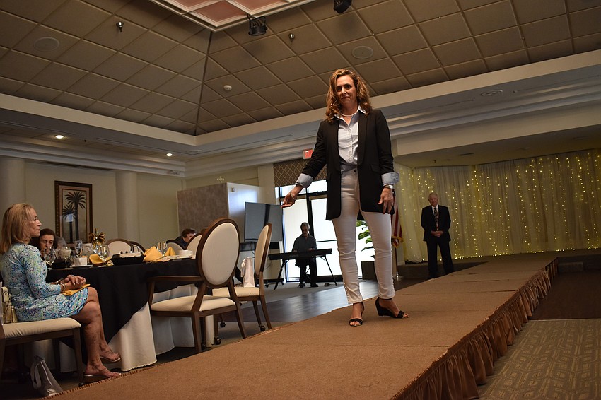 Palm Aire Women's Club member Lesa Hartigan walks the runaway during the Mission Possible fashion show.