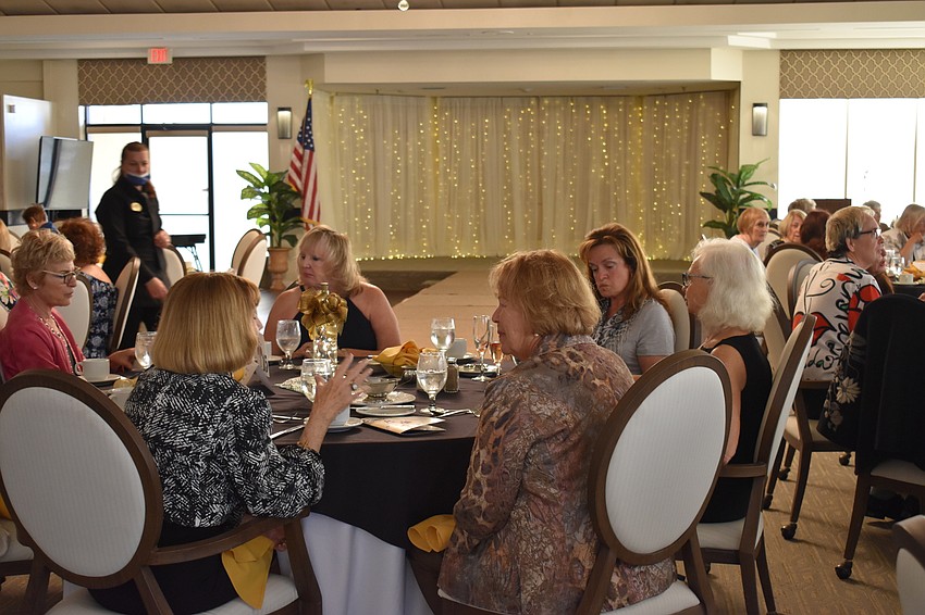 Attendees enjoy each other's company before the Palm Aire Women's Club Mission Possible fashion show begins.
