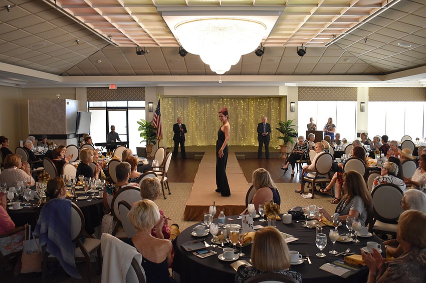 All eyes are on Katherine Pike, a Palm Aire fashion show committee member, as she walks the runway.