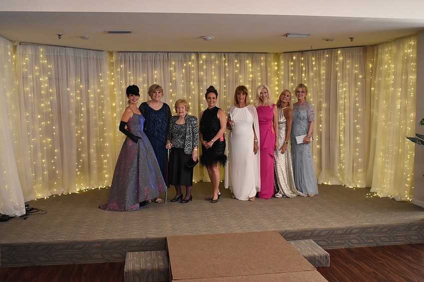 The models pose during the grand finale. From left to right are Katherine Pike, Debi Frock, Joan Greene, Lesa Hartigan, Kathleen Allan, Melody Dickerson, Kay Kwenski and Jane Herrin.