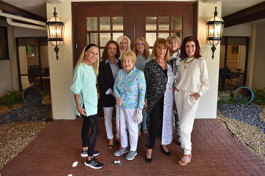 The Mission Possible models pose for a photo. They are Kay Kwenski, Lesa Hartigan, Joan Greene, Melody Dickerson, Jane Herrin, Kathleen Allan, Debi Frock and Katherine Pike.