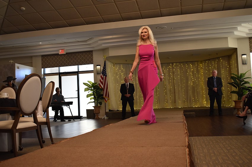Melodie Dickerson, the music program manager at State College of Florida, wears a colorful outfit on the runway.