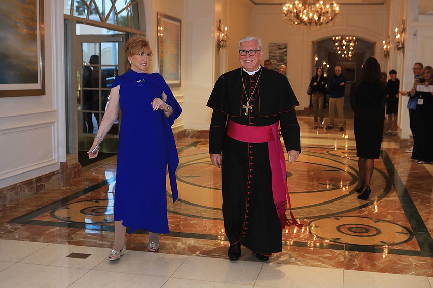 Chairwoman Bridget Spiess accompanies  Rev. Frank Dewane into the hotel.