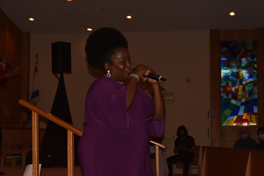 Syreeta Banks makes a heart to the audience.