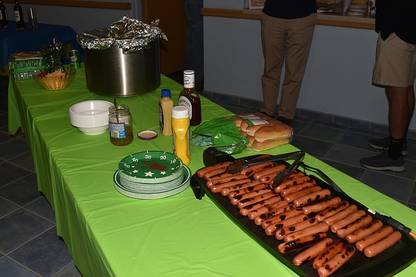 The table was laden with foods you'd also find at a tailgate.