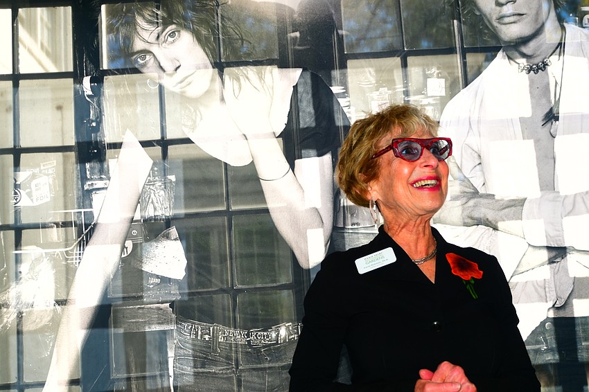 Dr. Carol Ockman speaks in front of an image of Patti Smith and Robert Mapplethorpe. (Photo: Spencer Fordin)