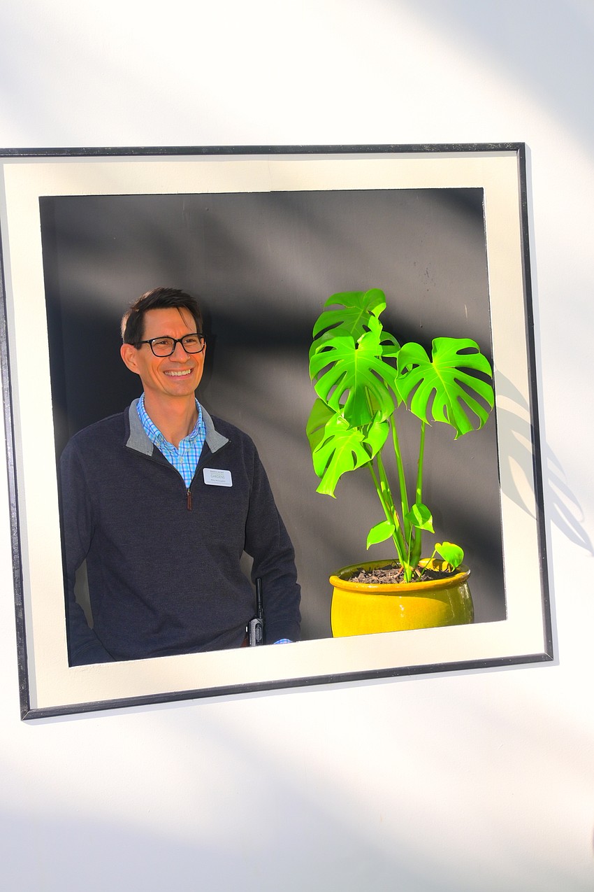 Horticulturalist Mike McLaughlin stands in the Self Portrait frame of the exhibit. (Photo: Spencer Fordin)