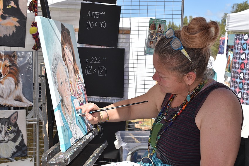 Mariah Hope works on a custom portrait during the market.