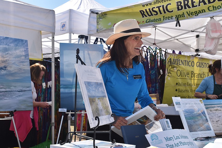 Mary Lou Johnson signs a book.