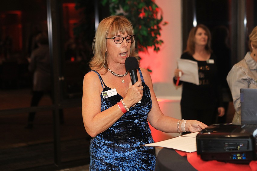 Co-chairwoman Roxanne Sima speaks to the audience.