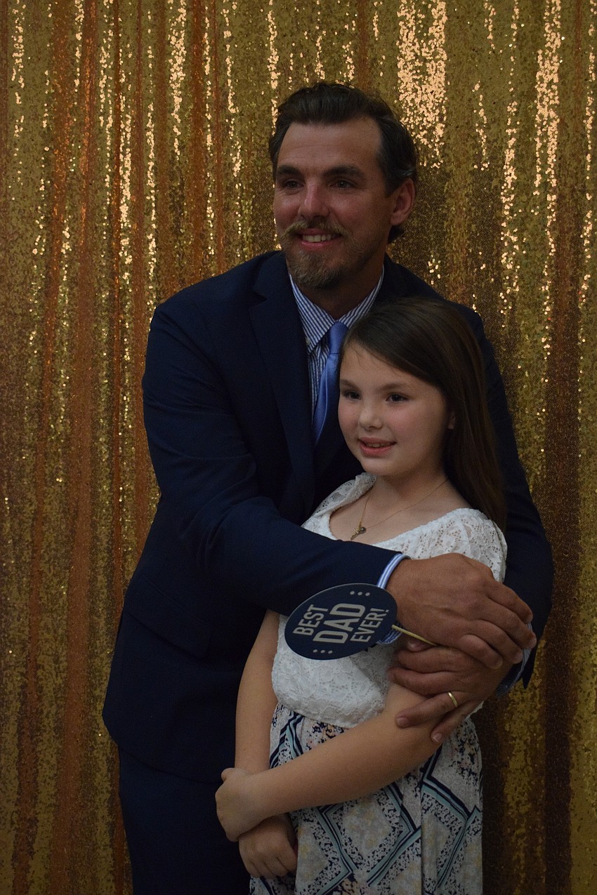 Travis Buckman and his daughter Tatum Buckman, a third grader, get on the dance floor.
