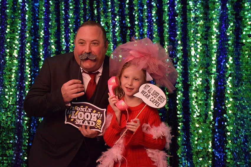 Dan Stephens and his daughter Summer, who is a third grader, grab props for a funny photo.