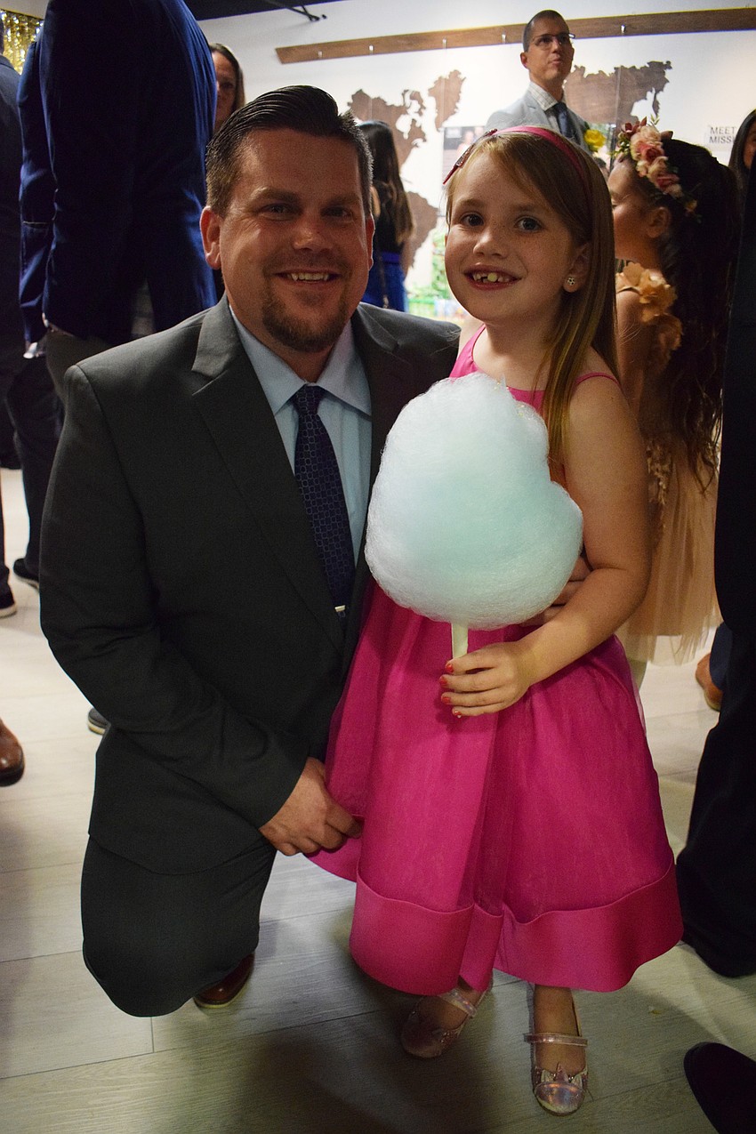 Scott Flynn and his daughter Emmy Flynn, who is a second grader, can't wait to get on the dance floor.