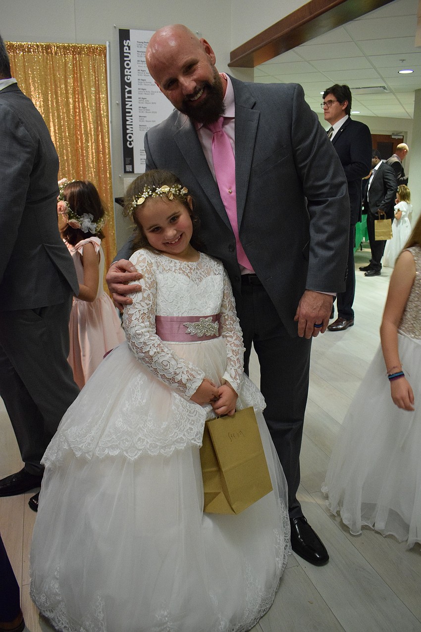 Stella Gerardot, a first grader, dresses for the Enchanted Ball theme with her father, Johnny Gerardot. It was their first father-daughter dance since last year's dance was canceled due to COVID-19.