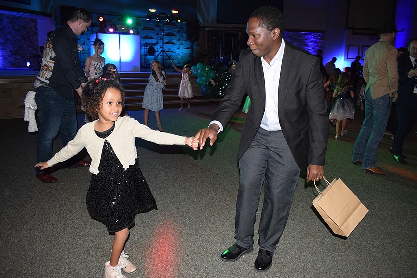 Ellie Gehndyu, a kindergartner, enjoys her first father-daughter dance with her father, Janjay Gehndyu.
