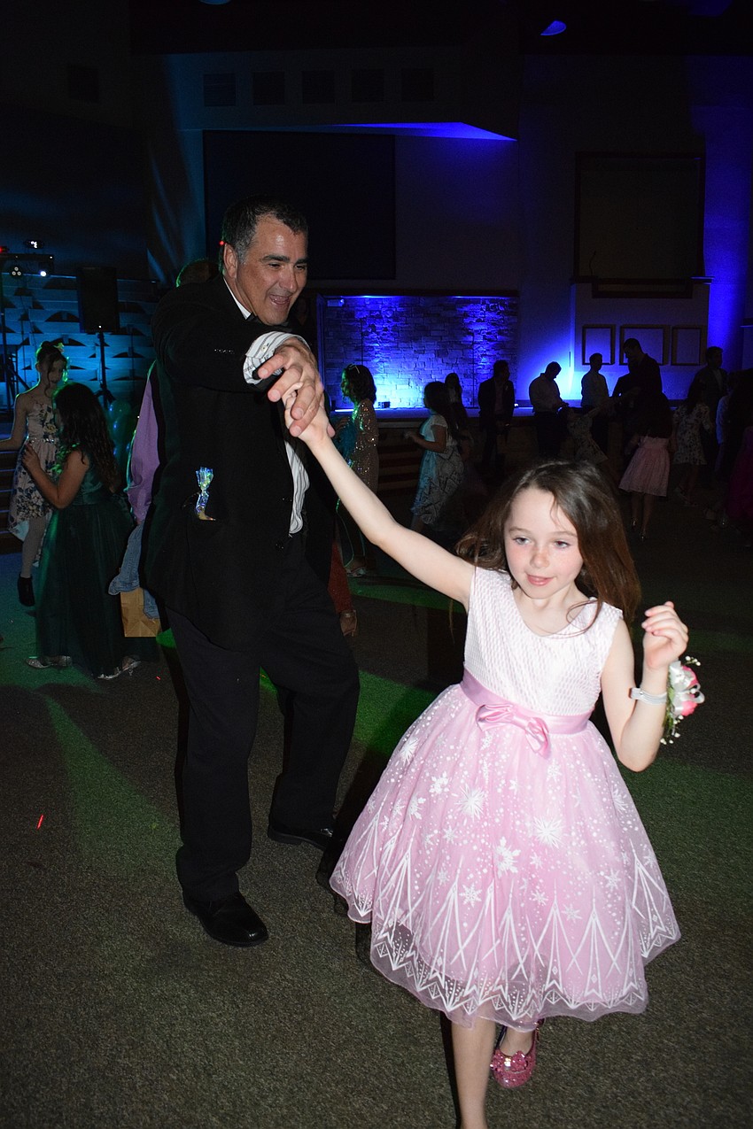 Tim McGoff twirls his daughter Brooke McGoff, who is a first grader.
