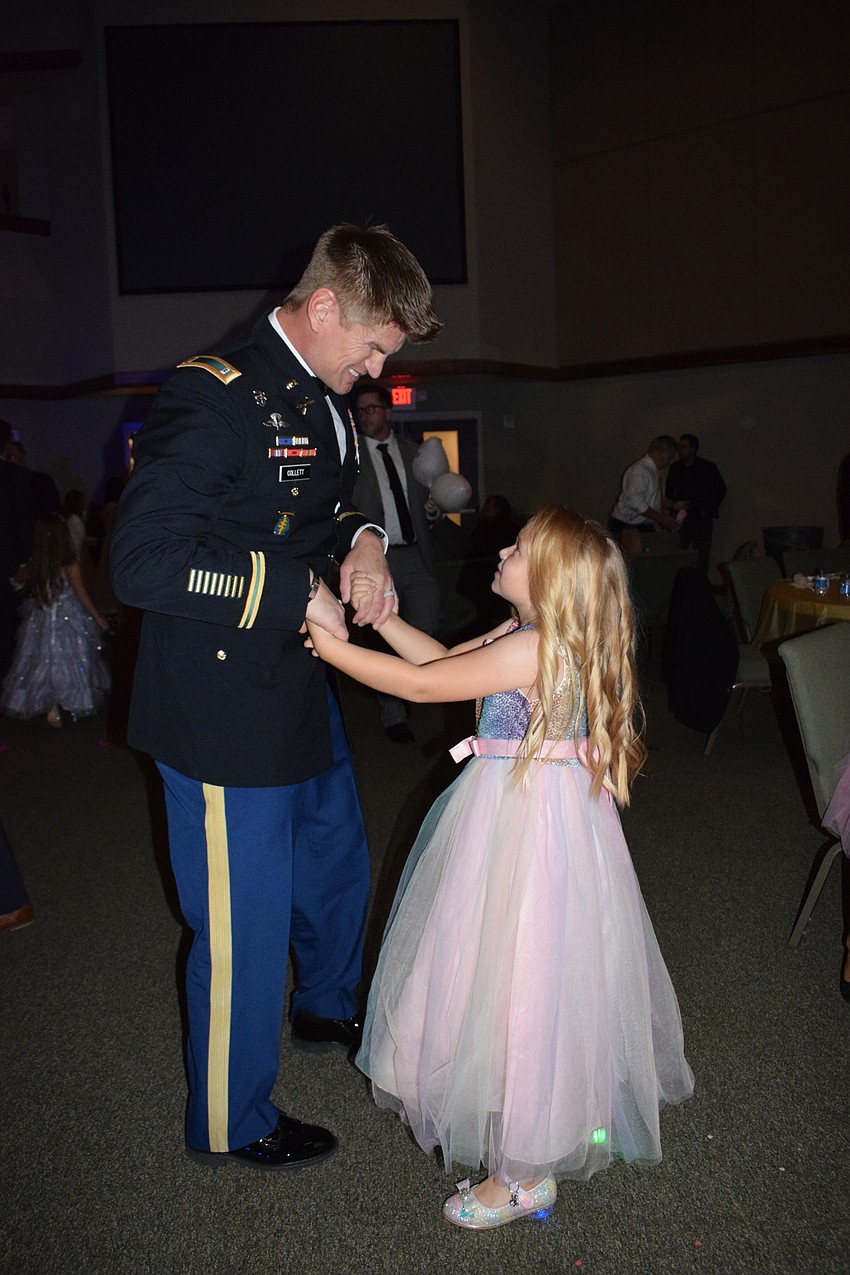 Steven Collett dances with his daughter Baylor Collett, a first grader.