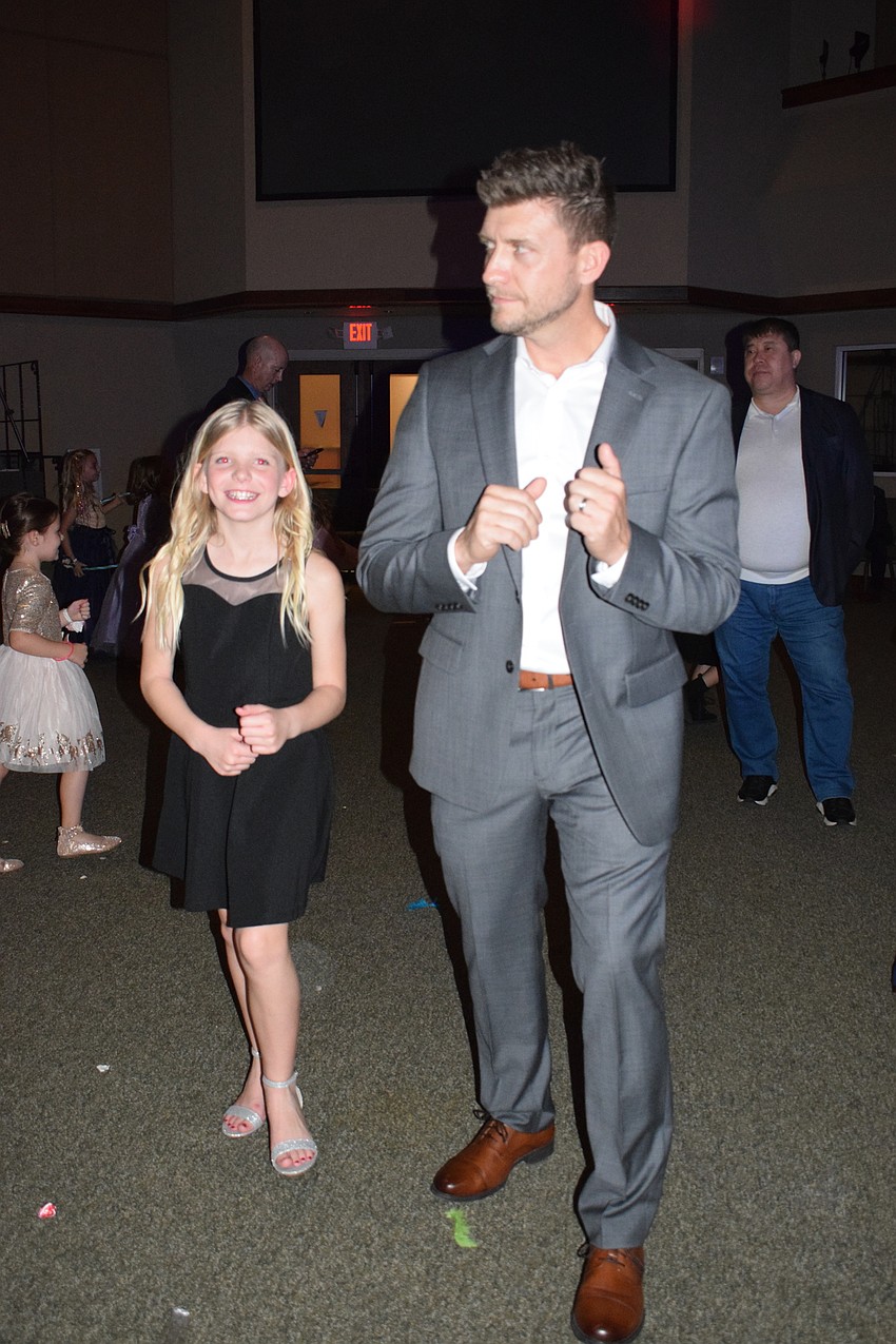 Adyson Shortridge, a fifth grader, does the Cha-Cha Slide with her father, Kale Shortridge, during their last father-daughter dance together.