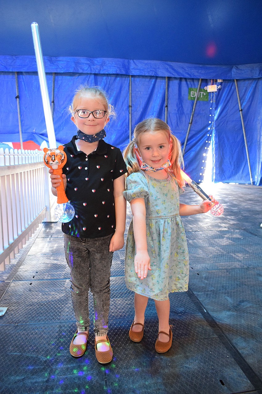 Parrish's Poppy McGrath, who is 7 years old, and 4-year-old Beatrix McGrath look forward to seeing Caleb Carinci perform with his horses.