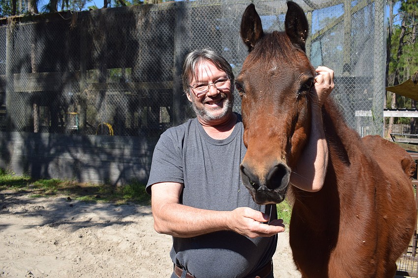 Dave Burns stands with Danny, who is 30 years old and who was the first animal who under the care of Dave and Lisa Burns.