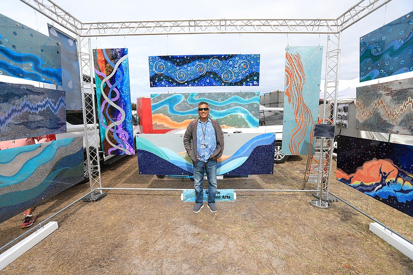 Sanjib Malik stands among his translucent  artwork.