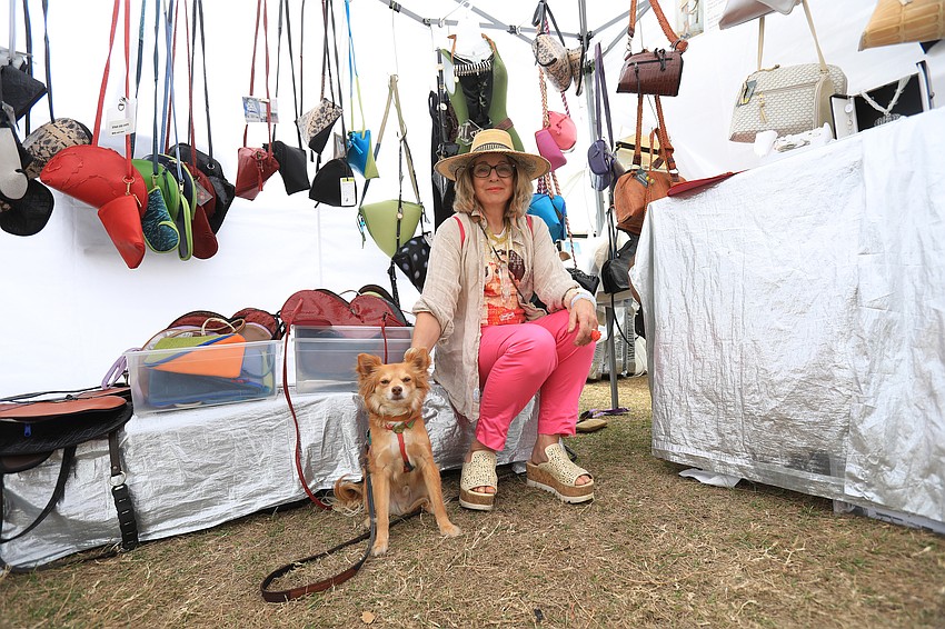 Carol Hearty  sells her handbags with her dog Russ.