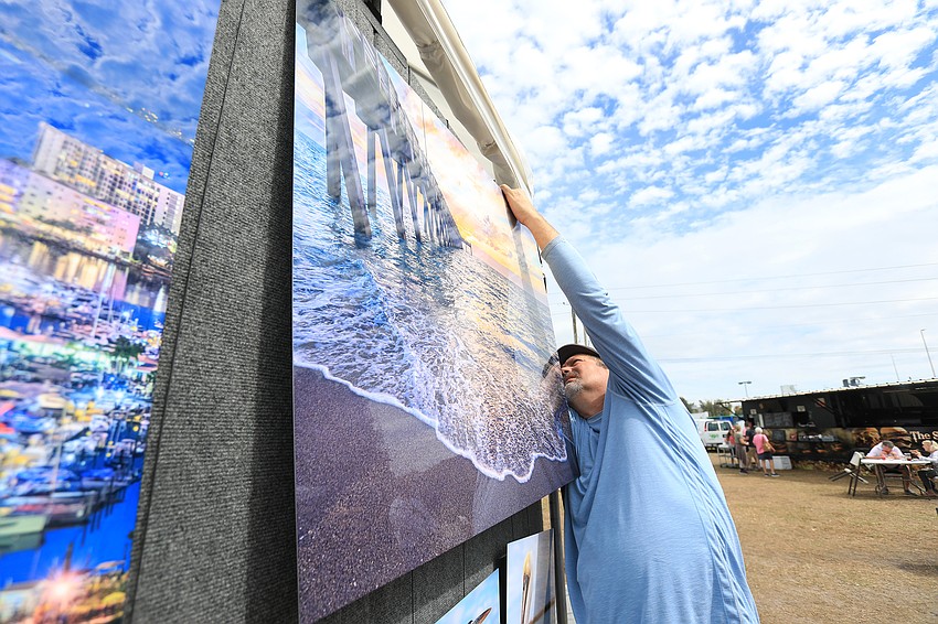 Craig Sheffield readjusts his photography selections.