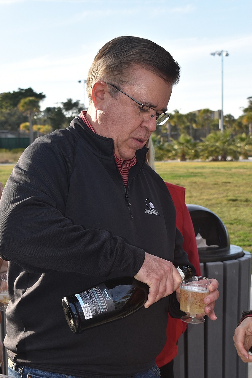 Frank Garcia pours champagne.