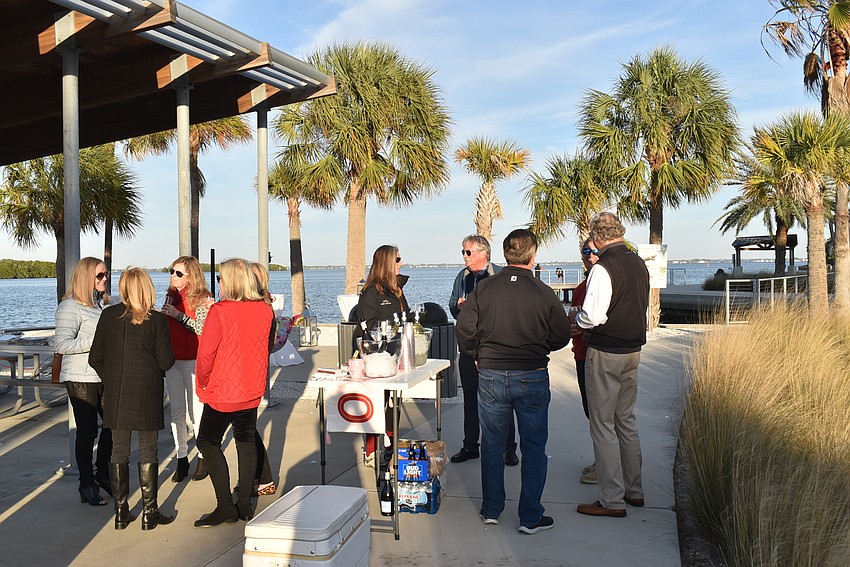 Attendees gathered near the champagne and the warmth of the sun.