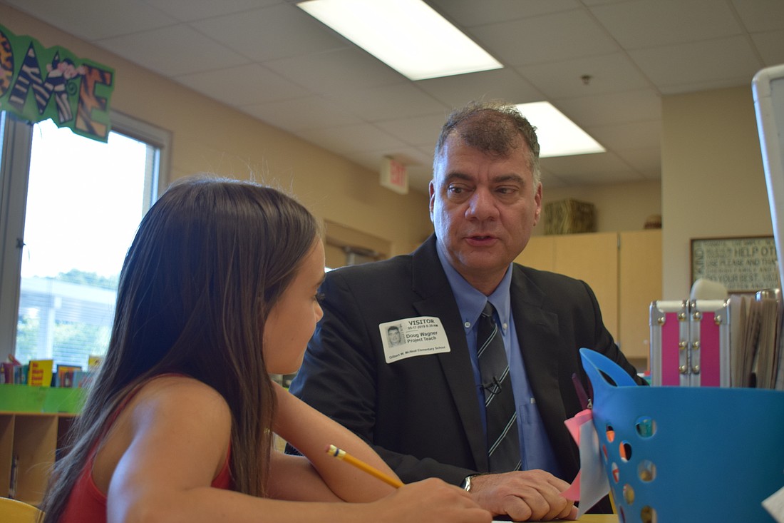 Stokely Browne, a fourth grader at Gilbert W. McNeal Elementary School, talks to Doug Wagner, the deputy superintendent of operations for the School District of Manatee County, about becoming a neurosurgeon. File photo