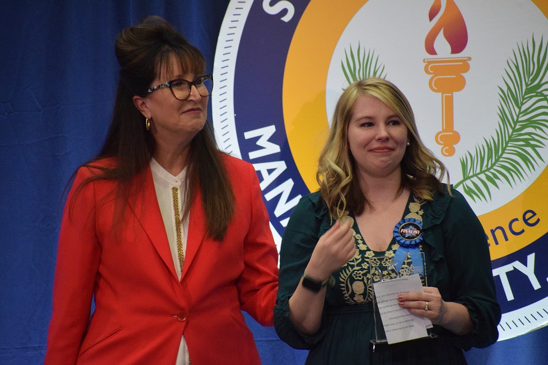 Cynthia Saunders, the superintendent of the School District of Manatee County, congratulates Kari Keech-Babcock, a guidance clerk at Lakewood Ranch High School, for winning the district&#39;s Support Employee of the Year.