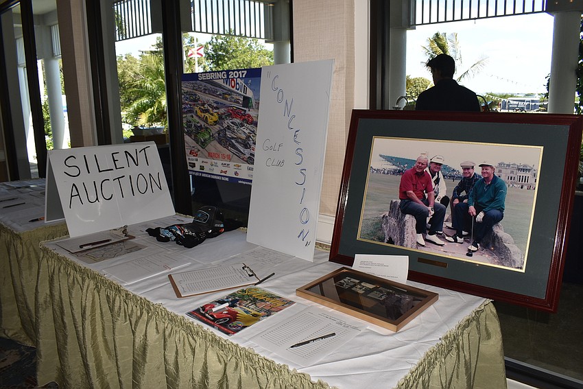 Attendees bid on silent auction items before and after lunch.