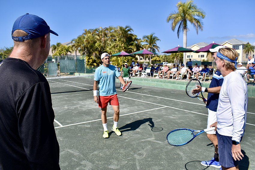 Tommy Haas meets his first group of clinic participants on court.