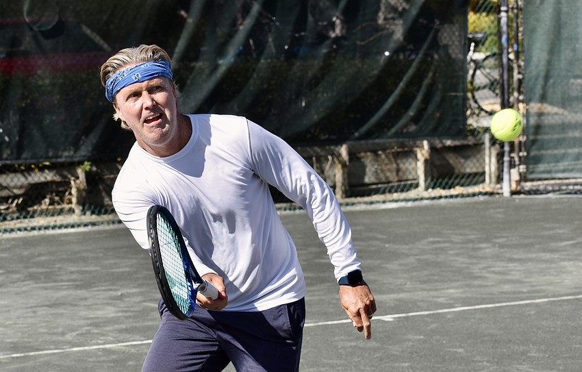 Steve Willoughby makes a volley at the net.